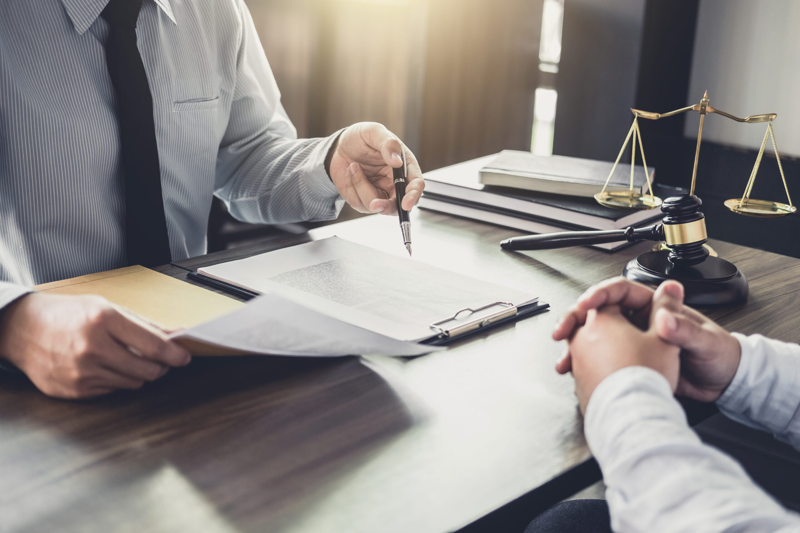 Lawyer consults his client about the specifics of a legal document.