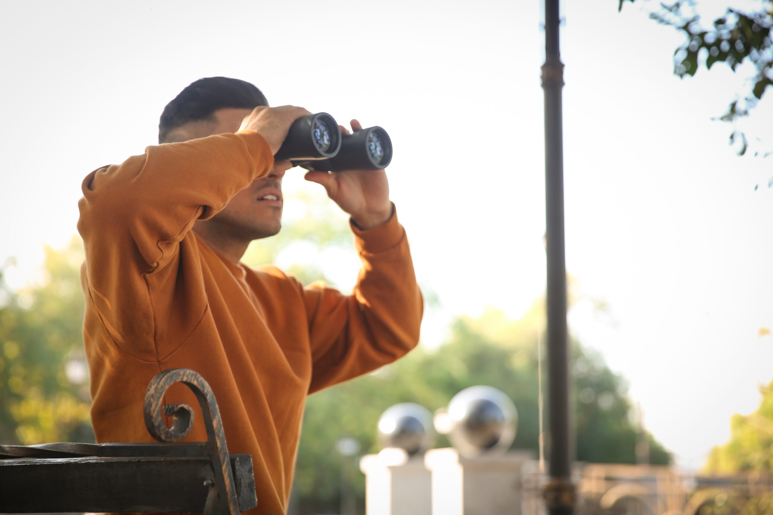 Man uses sneaky divorce tactics to spy on ex wife in park using a pair of binoculars